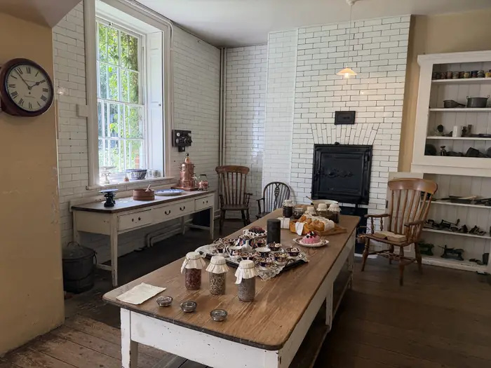 Below stairs — the Victorian kitchen, all copper and scrubbed pine.